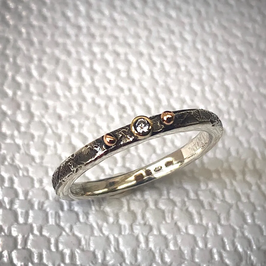Solid sterling silver and gold ring set with a sparkling 2mm Diamond. Size R