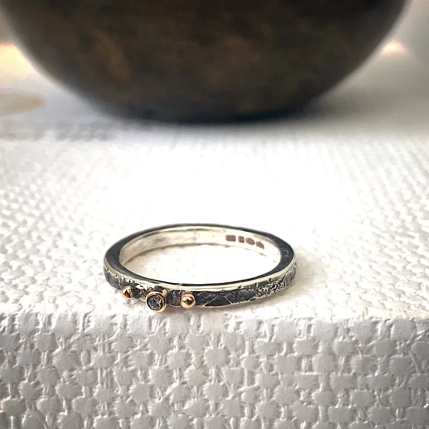 Solid sterling silver and gold ring set with a sparkling 2mm Diamond. Size R