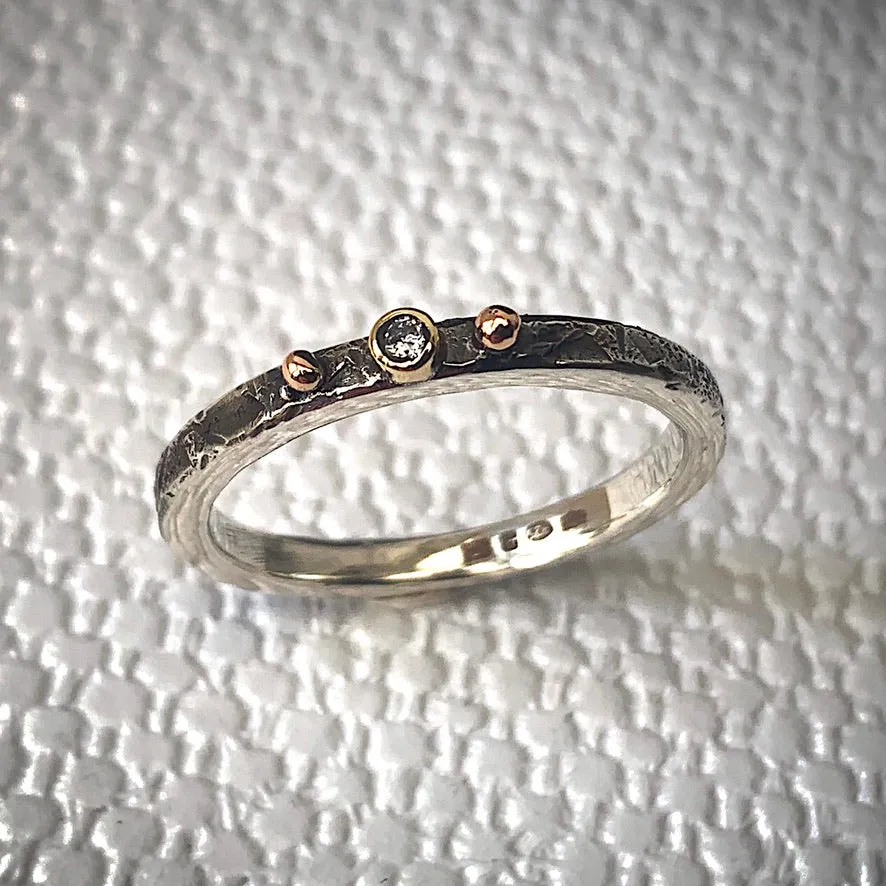 Solid sterling silver and gold ring set with a sparkling 2mm Diamond. Size R